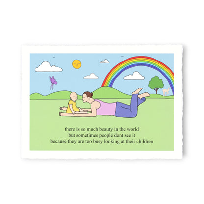 Cartoon of a woman and child lying on grass with a rainbow and text about seeing beauty in the world.