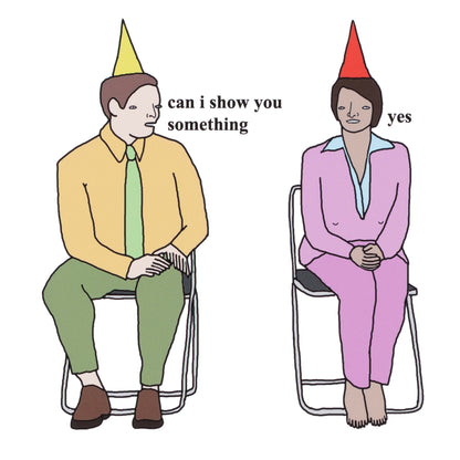Two people sitting on chairs with party hats, one asking if they can show something to the other.