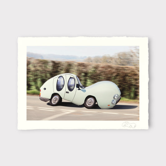 Unusual vehicle driving on a road with trees in the background